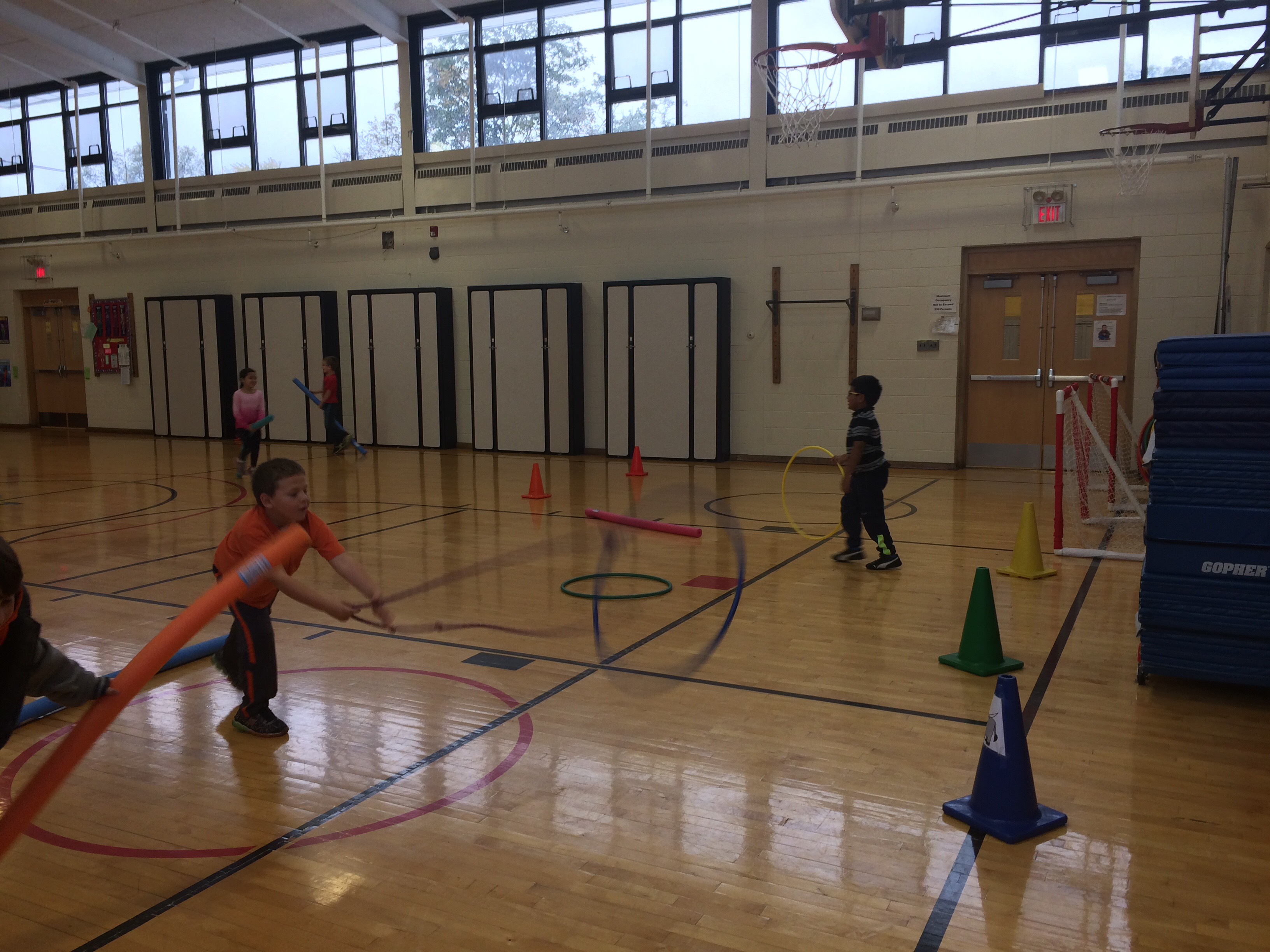 Students playing the lasso a cone game