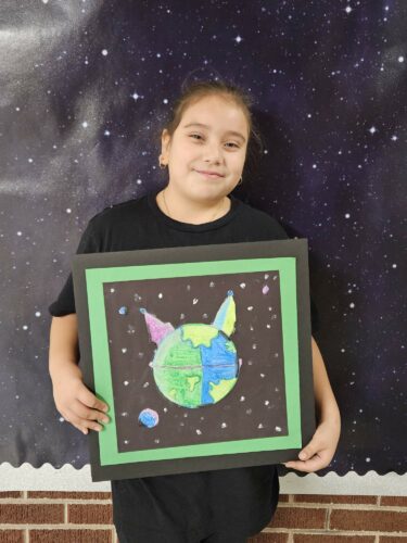 Kassandra Ramos Barraza shows off her artwork.