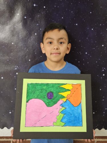 Luis Jimenez Castro shows off his artwork.