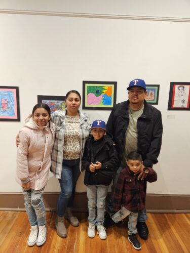 Luis and family celebrate his achievement at the Winter Art Garden.